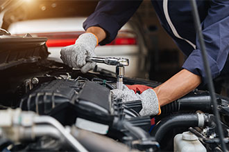 Automobile mechanic repairman hands repairing a car engine automotive workshop with a wrench, car service and maintenance,Repair service.