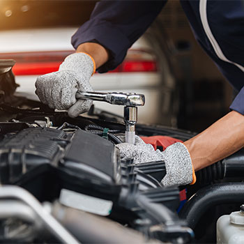 Automobile mechanic repairman hands repairing a car engine automotive workshop with a wrench, car service and maintenance,Repair service.